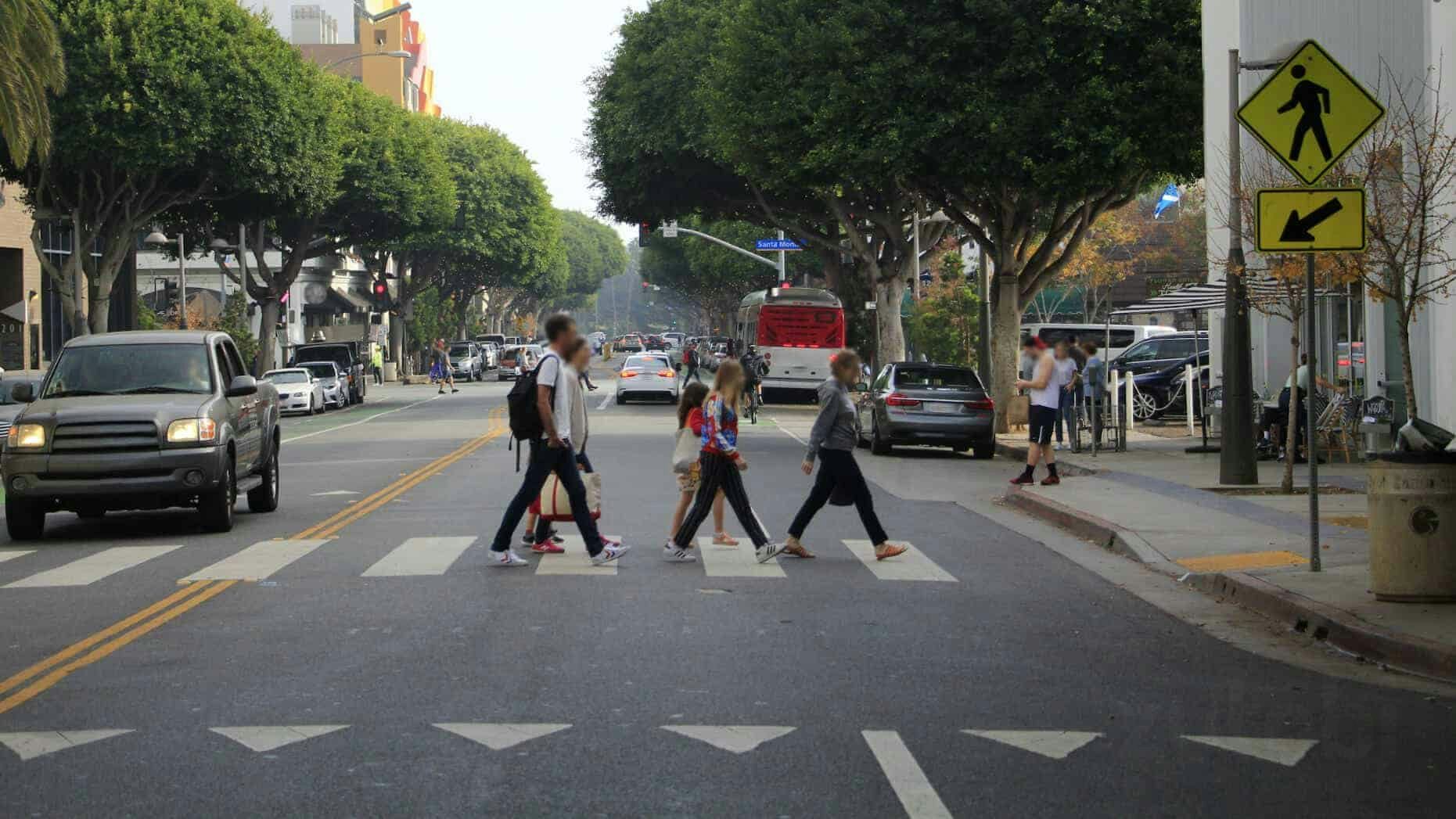 A group of young people at a marked crosswalk