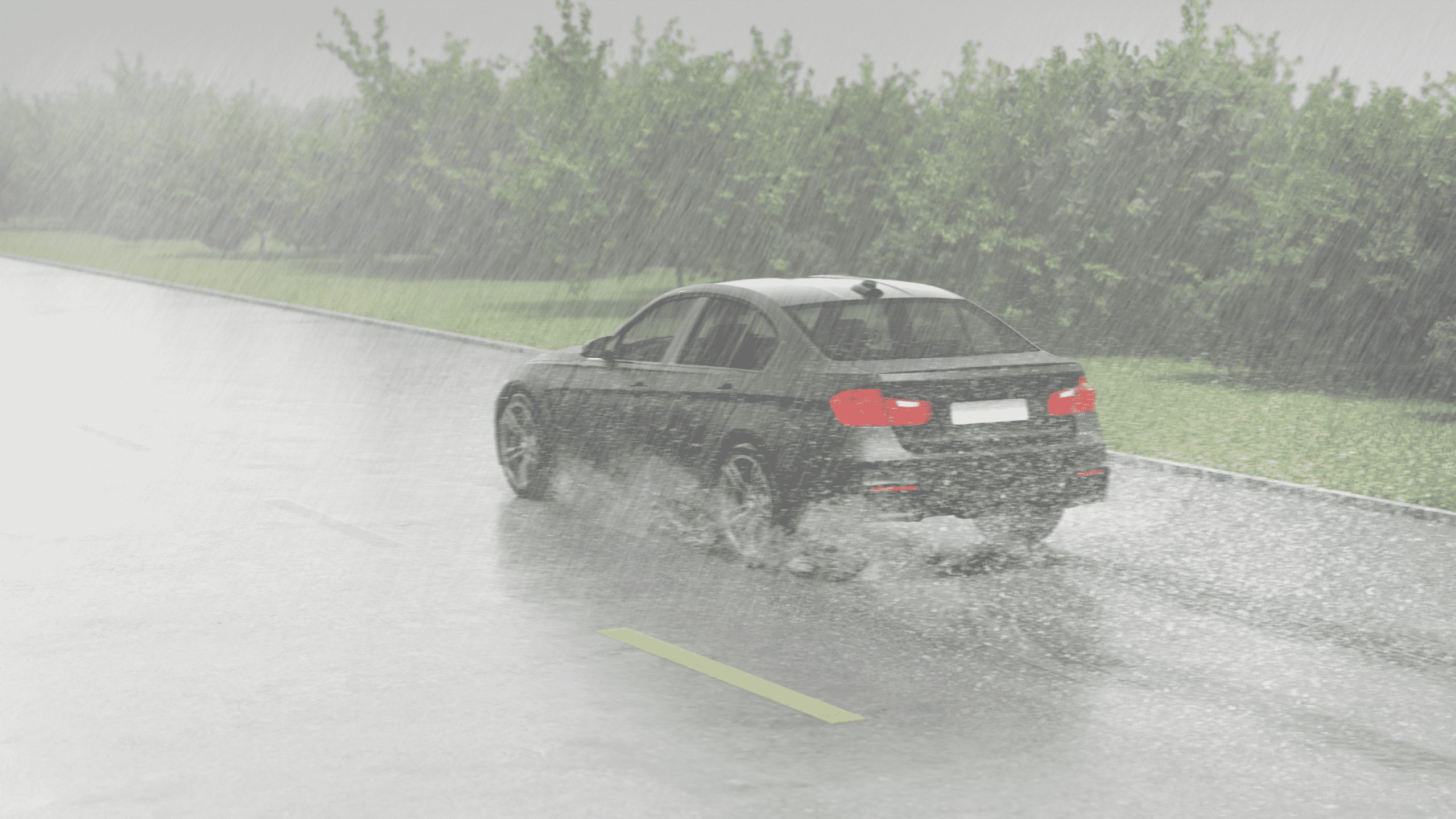 roadway with a lot of water and a car