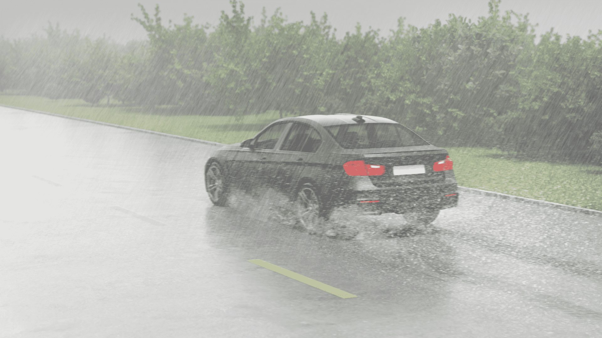 roadway with a lot of water and a car
